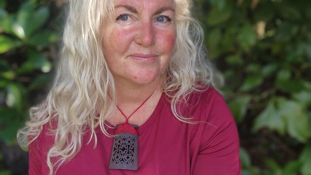 Sonia Therese, jewellery designer, wearing a sandalwood toki pendant